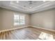 Sunlit bedroom with tray ceiling, ceiling fan and wood-look flooring at 217 Shady Pines Ct., Conway, SC 29527
