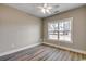 Bedroom with wood-look flooring, ceiling fan, and bright window at 217 Shady Pines Ct., Conway, SC 29527