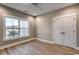 Bright bedroom featuring wood floors, closet and large window at 217 Shady Pines Ct., Conway, SC 29527