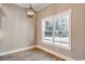 Cozy dining room with a modern chandelier and large window showcasing the outdoor scenery at 217 Shady Pines Ct., Conway, SC 29527