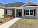 Close-up of a home's front entrance with stone accents and well manicured landscaping at 217 Shady Pines Ct., Conway, SC 29527