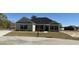 Inviting single-story home with stone accents, black shutters, and a well-manicured lawn at 217 Shady Pines Ct., Conway, SC 29527