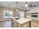 Bright kitchen with an island, stainless steel appliances, and open layout to living area at 217 Shady Pines Ct., Conway, SC 29527