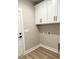 A laundry room with white cabinets for storage and a door leading outside at 217 Shady Pines Ct., Conway, SC 29527