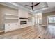Spacious living room featuring a modern fireplace, built-ins, and wood-look flooring at 217 Shady Pines Ct., Conway, SC 29527