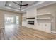 Inviting living room featuring a fireplace, custom built-ins, wood flooring, and recessed lighting at 217 Shady Pines Ct., Conway, SC 29527