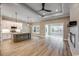 Open-concept living space featuring wood floors, kitchen island, and ample natural light at 217 Shady Pines Ct., Conway, SC 29527