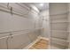 Organized walk-in closet with metal shelving and wood-look flooring at 217 Shady Pines Ct., Conway, SC 29527
