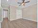 Bright bedroom with neutral walls features a ceiling fan and closet, and light wood floors at 2515 Saint Andrews Dr., Little River, SC 29566