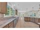 Open-concept kitchen with stainless steel appliances, island, and plenty of natural light at 2515 Saint Andrews Dr., Little River, SC 29566