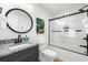 Well-lit bathroom featuring a granite countertop vanity and a shower with sliding glass doors at 6205 Nixon St., North Myrtle Beach, SC 29582