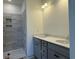 Bathroom featuring double sinks with a gray vanity and a shower at 1009 Jase Dr., Longs, SC 29568