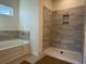 Bathroom with tiled shower/tub combo and a large window at 1009 Jase Dr., Longs, SC 29568