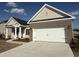 Charming single-story home featuring a two-car garage and neutral-colored siding and brick accents at 1009 Jase Dr., Longs, SC 29568