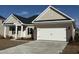 Charming single-story home featuring a two-car garage and neutral-colored siding and brick accents at 1009 Jase Dr., Longs, SC 29568