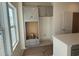 An unfinished kitchen features gray cabinets and drawers, a window with natural light, and a cutout for the refrigerator at 1009 Jase Dr., Longs, SC 29568