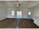 Open concept living room with large windows and a ceiling fan at 1009 Jase Dr., Longs, SC 29568