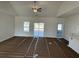 Bright living room with high ceilings, a ceiling fan, and big windows covered with paper at 1009 Jase Dr., Longs, SC 29568