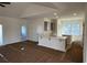 Open-concept area that connects the kitchen and the living room and has paper on the floors at 1009 Jase Dr., Longs, SC 29568