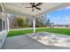 Inviting covered patio with ceiling fan, spacious concrete, and green lawn at 1101 Anne St., North Myrtle Beach, SC 29582