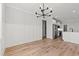Dining room with wainscoting, hardwood floors, and flows into the modern kitchen at 1101 Anne St., North Myrtle Beach, SC 29582