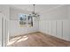Dining room with wainscoting, hardwood floors, and a modern chandelier at 1101 Anne St., North Myrtle Beach, SC 29582
