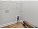 Bright laundry room with white walls, wood-look floors, and wire shelving for efficient storage solutions at 1101 Anne St., North Myrtle Beach, SC 29582