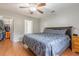 Bedroom featuring wood floors, fan, and closet and bathroom access at 1200 Bergen Dr., Loris, SC 29569