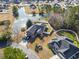 A high-angle shot shows a brick home with waterfront access, nestled among lush landscaping in a serene community at 305 Duel Ct., Myrtle Beach, SC 29588