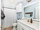 Bright bathroom features white cabinets, modern fixtures, and a shower with a neutral-toned shower curtain at 305 Duel Ct., Myrtle Beach, SC 29588