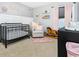 Charming Bedroom featuring a black crib, rocking chair, and personalized wall décor for a cozy, welcoming space at 305 Duel Ct., Myrtle Beach, SC 29588