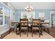 Bright dining room with natural light, comfortable seating and modern chandelier for Gathering gatherings and entertaining with neutral decor at 305 Duel Ct., Myrtle Beach, SC 29588