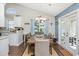 Bright dining room with cathedral ceilings and a seamless transition to kitchen and outdoor area that's perfect for hosting dinner parties at 305 Duel Ct., Myrtle Beach, SC 29588