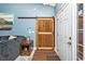 Inviting entryway features a striking wooden barn door, stylish accents, and durable wood flooring for a modern and welcoming entrance at 305 Duel Ct., Myrtle Beach, SC 29588