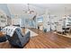 A spacious living room flows seamlessly into the dining area and boasts wood-look floors, vaulted ceilings, and modern decor at 305 Duel Ct., Myrtle Beach, SC 29588