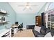 Inviting home office with ample natural light, a comfortable sofa, and a functional workspace at 305 Duel Ct., Myrtle Beach, SC 29588