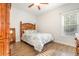 Bright bedroom features wood-look flooring, ceiling fan, and tropical-themed furnishings at 76 Eagle Pass Dr., Murrells Inlet, SC 29576