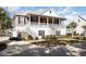 Inviting two-story home with double porches, enhanced by meticulous landscaping and serene surroundings at 76 Eagle Pass Dr., Murrells Inlet, SC 29576