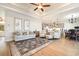 Bright living room featuring tray ceilings, modern furnishings, and an open floor plan into the kitchen at 76 Eagle Pass Dr., Murrells Inlet, SC 29576