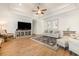 Open-concept living room with hardwood floors, modern decor, ceiling fan and accent wall at 76 Eagle Pass Dr., Murrells Inlet, SC 29576