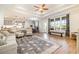 Open-concept living room with hardwood floors, large windows, and access to the kitchen at 76 Eagle Pass Dr., Murrells Inlet, SC 29576