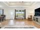 Elegant living room featuring hardwood floors, coffered ceilings, and a large window with bench seating at 76 Eagle Pass Dr., Murrells Inlet, SC 29576