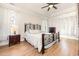A spacious bedroom with hardwood floors, natural light, and modern ceiling fan at 76 Eagle Pass Dr., Murrells Inlet, SC 29576