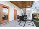 Outdoor patio with dining table and chairs, adjacent to white house with orange doors at 76 Eagle Pass Dr., Murrells Inlet, SC 29576