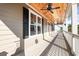 Enjoy outdoor living on this spacious porch with a beautiful wood ceiling and a ceiling fan at 76 Eagle Pass Dr., Murrells Inlet, SC 29576
