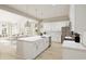 Modern white kitchen with large island and stainless steel appliances at 870 Foxtail Dr. # C-35, Longs, SC 29568