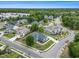 Aerial shot highlighting a blue home, surrounded by green lawns and mature trees within a community at 1201 Surf Pointe Dr., North Myrtle Beach, SC 29582