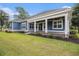 Back of home featuring a covered patio, well-maintained lawn, and a beautiful outdoor living space at 1201 Surf Pointe Dr., North Myrtle Beach, SC 29582