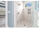 Glass enclosed shower with marble tile surround, recessed shower caddy and showerhead at 1201 Surf Pointe Dr., North Myrtle Beach, SC 29582