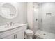 The bathroom features a round mirror and glass shower with tile surround at 1201 Surf Pointe Dr., North Myrtle Beach, SC 29582